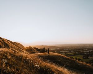 Preview wallpaper hills, man, silhouette, sunset, landscape