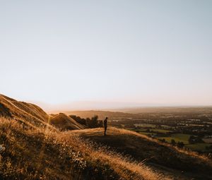 Preview wallpaper hills, man, silhouette, sunset, landscape