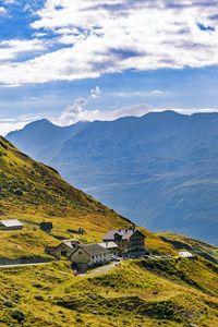 Preview wallpaper hills, mountains, slope, houses, grass, sky