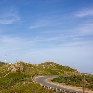 Preview wallpaper hills, road, turn, stones, sky