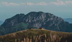 Preview wallpaper hills, rocks, flowers, wildflowers, building