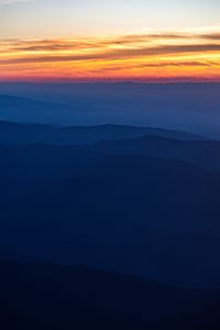 Preview wallpaper hills, silhouettes, mountains, sunset, sky