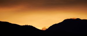 Preview wallpaper hills, silhouettes, sunset, sky, dusk, evening