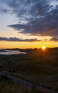 Preview wallpaper hills, sun, sunset, sea, road, grass