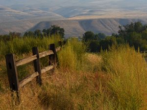 Preview wallpaper hills, trees, fence, nature, landscape