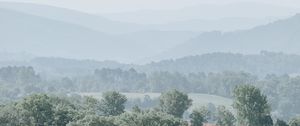 Preview wallpaper hills, trees, fog, horizon, landscape