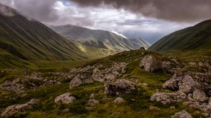 Preview wallpaper hills, valley, clouds, stones, grass