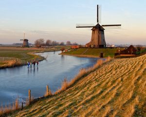 Preview wallpaper holland, mill, lake, sand, grass, sky