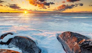 Preview wallpaper horizon, sunset, stones, ice, snow