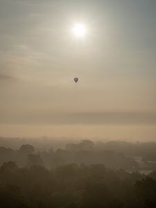 Preview wallpaper hot air balloon, sky, sun, light, forest, trees, fog