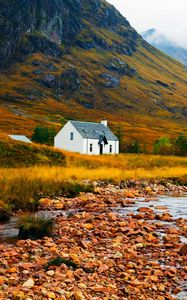 Preview wallpaper house, lake, stones, grass, mountains