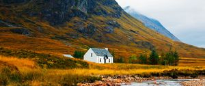 Preview wallpaper house, lake, stones, grass, mountains