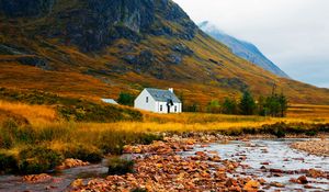 Preview wallpaper house, lake, stones, grass, mountains