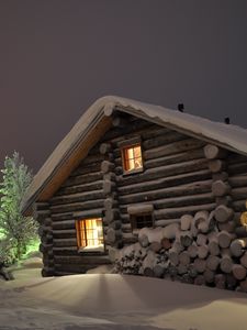 Preview wallpaper house, light, windows, winter, snowdrifts, logs