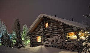 Preview wallpaper house, light, windows, winter, snowdrifts, logs