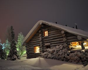 Preview wallpaper house, light, windows, winter, snowdrifts, logs