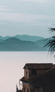 Preview wallpaper house, sea, mountains, fog, building, shore