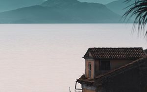 Preview wallpaper house, sea, mountains, fog, building, shore