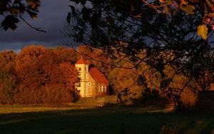 Preview wallpaper house, trees, autumn, branches, shade, clouds, sky