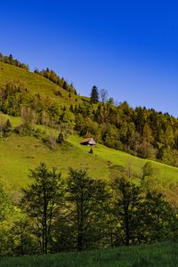 Preview wallpaper house, trees, hill, mountains, sky, nature