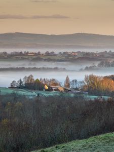 Preview wallpaper houses, hills, trees, fog, aerial view