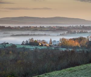 Preview wallpaper houses, hills, trees, fog, aerial view