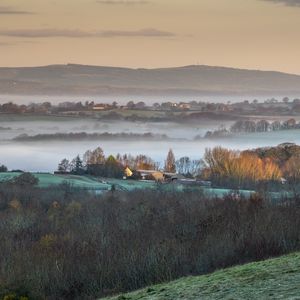 Preview wallpaper houses, hills, trees, fog, aerial view