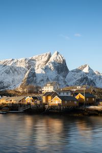 Preview wallpaper houses, pier, mountains, snow, sea