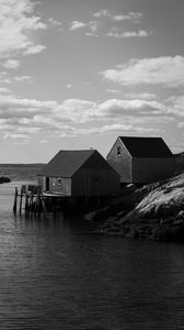 Preview wallpaper houses, river, pier, piles, bw