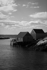 Preview wallpaper houses, river, pier, piles, bw