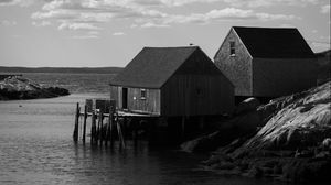 Preview wallpaper houses, river, pier, piles, bw