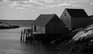 Preview wallpaper houses, river, pier, piles, bw