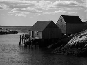 Preview wallpaper houses, river, pier, piles, bw