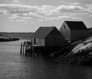 Preview wallpaper houses, river, pier, piles, bw