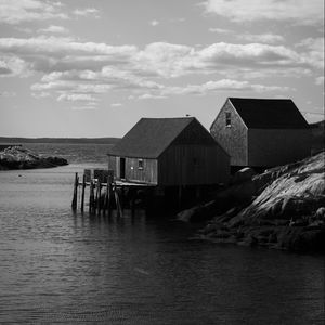 Preview wallpaper houses, river, pier, piles, bw