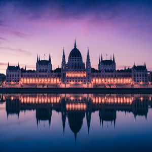 Preview wallpaper hungary, building, sunset, facade, lights