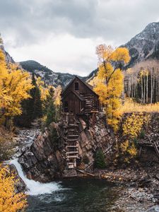 Preview wallpaper hut, rock, trees, river, autumn, landscape