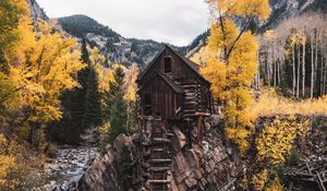 Preview wallpaper hut, rock, trees, river, autumn, landscape