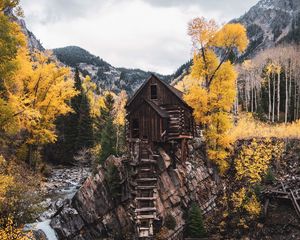 Preview wallpaper hut, rock, trees, river, autumn, landscape