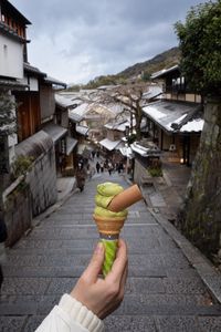 Preview wallpaper ice cream, dessert, hand, street, buildings, japan