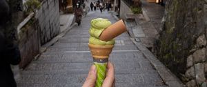 Preview wallpaper ice cream, dessert, hand, street, buildings, japan