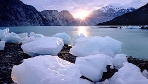 Preview wallpaper ice, pieces, blocks, coast, sun, mountains, horizon