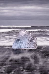 Preview wallpaper ice, rock, sea, waves, clouds