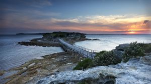 Preview wallpaper island, bridge, sea, stones, dusk