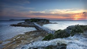 Preview wallpaper island, bridge, sea, stones, dusk