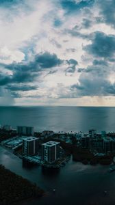 Preview wallpaper island, city, aerial view, clouds, sea, ocean, twilight