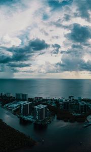 Preview wallpaper island, city, aerial view, clouds, sea, ocean, twilight