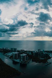 Preview wallpaper island, city, aerial view, clouds, sea, ocean, twilight