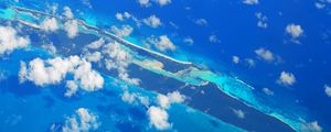 Preview wallpaper island, clouds, sea, aerial view, blue