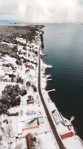 Preview wallpaper island, coast, aerial view, snow, buildings